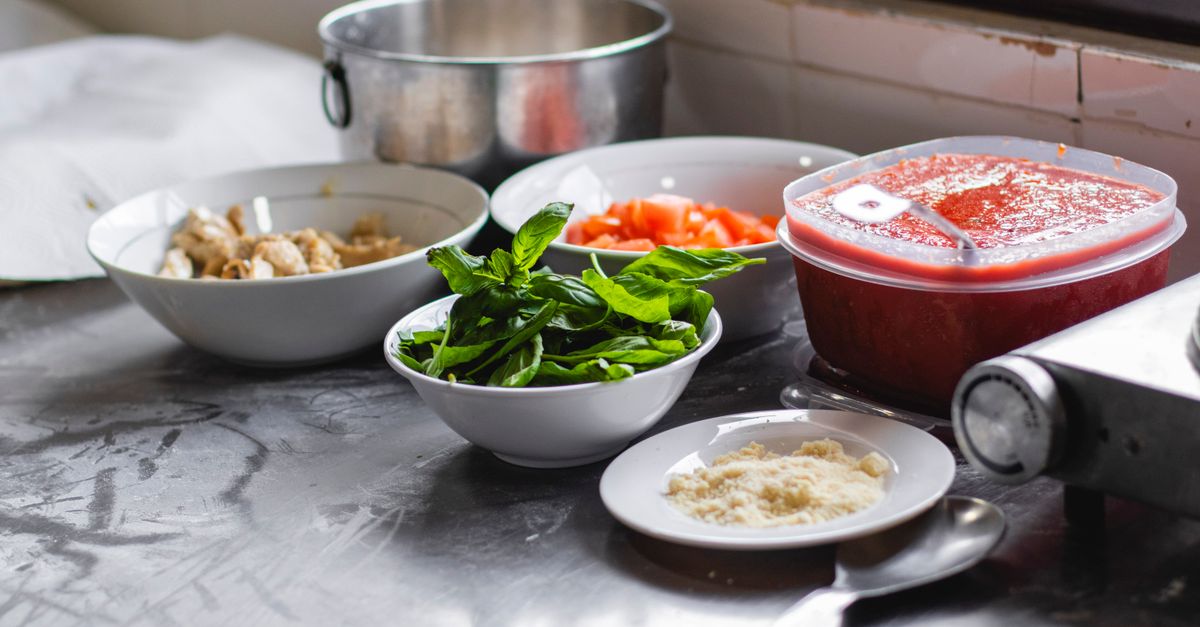 Home kitchen counter with prepared ingredients for a spiced rice and meat dish
